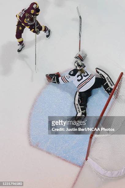 Aerin Frankel of the Northeastern Huskies attempts to poke the puck away from Anna Klein of the Minnesota Duluth Bulldogs in the overtime period of...
