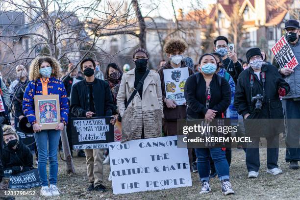 People hold signs during the "Asian Solidarity March" rally against anti-Asian hate in response to recent anti-Asian crime on March 18, 2021 in...