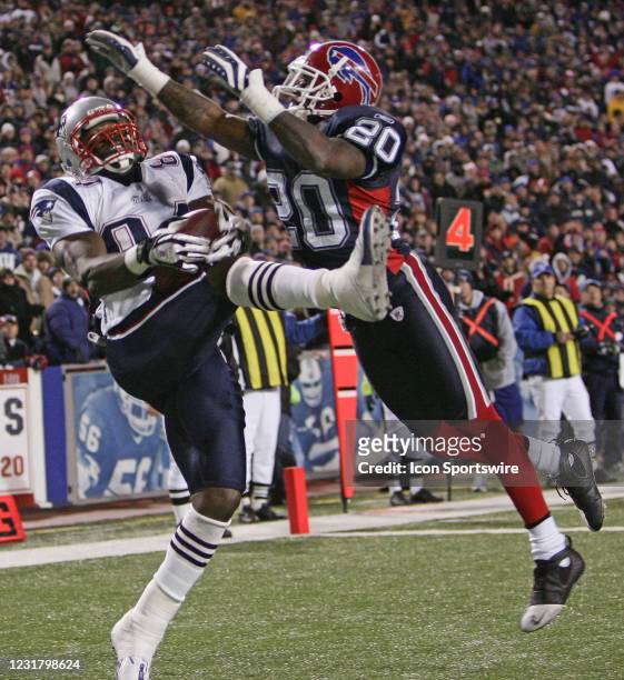 New England Patriots tight end Benjamin Watson grabs a touchdown pass over Buffalo Bills safety Donte Whitner during the game at Ralph Wilson Stadium...
