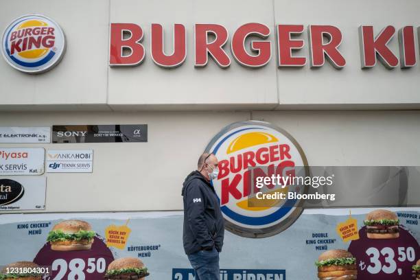 Pedestrian walks past a Burger King Corp. Restaurant, operated by TFI TAB Food Investments, in the Fatih district of Istanbul, Turkey, on Tuesday,...