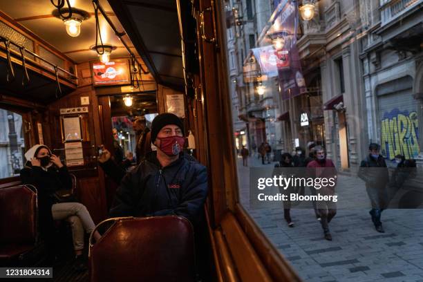 Passengers wear protective face masks on a tram car as it makes its way along Istiklal Street in Istanbul, Turkey, on Tuesday, March 16, 2021. Burger...
