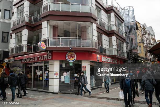 Pedestrians walk past a closed Burger King Corp. Restaurant, operated by TFI TAB Food Investments, in the Kadikoy neighborhood of Istanbul, Turkey,...
