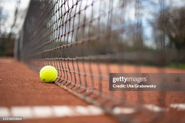 Dortmund, Germany In this photo illustration a tennis ball is next to the tennis net on March 17, 2021 in Dortmund, Germany.