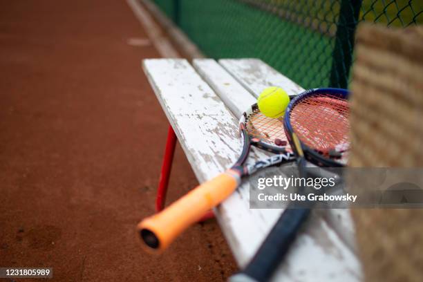 Dortmund, Germany In this photo illustration two rackets and a ball lying on a bench on March 17, 2021 in Dortmund, Germany.