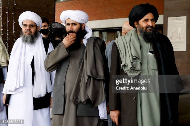 Taliban delegation headed by Abdul Ghani Baradar , the groups deputy leader, are seen leaving the hotel after attending the meeting on Afghan peace...