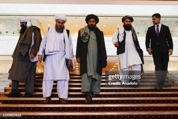 Taliban delegation headed by Abdul Ghani Baradar , the groups deputy leader, are seen leaving the hotel after attending the meeting on Afghan peace...
