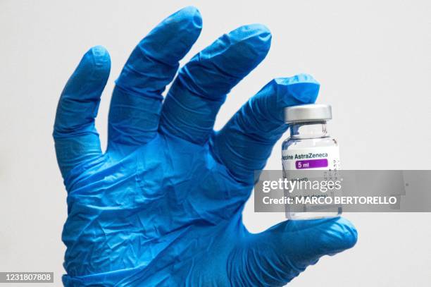 Medical worker holds a vial of the AstraZeneca vaccine against Covid-19 on March 19, 2021 at the San Giovanni Bosco Hospital in Turin. - Italy on...