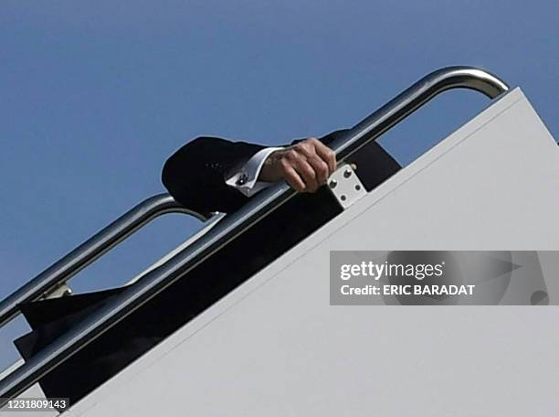 President Joe Biden trips while boarding Air Force One at Joint Base Andrews in Maryland on March 19, 2021. - President Biden travels to Atlanta,...