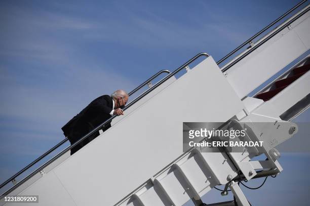President Joe Biden trips while boarding Air Force One at Joint Base Andrews in Maryland on March 19, 2021. President Biden travels to Atlanta,...