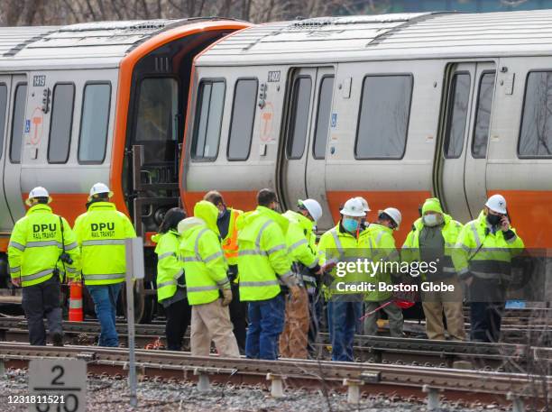 Officials inspecting the derailment of the Orange Line T train just outside the Wellington MBTA station in Medford, MA on March 16, 2021.