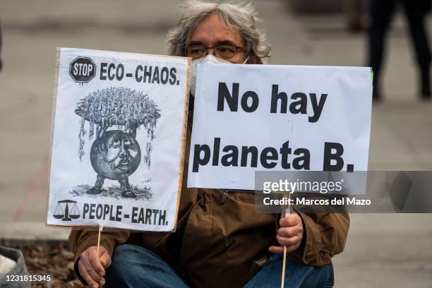 Climate change activist of 'Fridays for Future' group protesting with placards in front of the Spanish Parliament calling for action in climate...