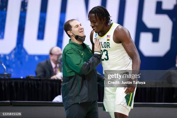 Head coach Scott Drew and Jonathan Tchamwa Tchatchoua of the Baylor Bears celebrate defeating the Hartford Hawks during the first round of the 2021...