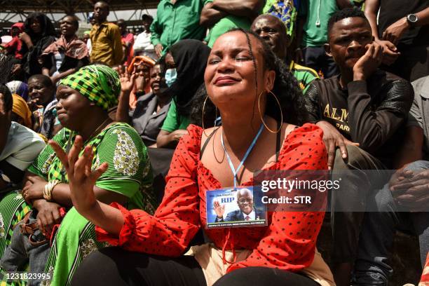 Woman cries as attendees mourn the death of the coffin of fifth Tanzanian president John Magufuli during the national funeral at Uhuru Stadium in Dar...