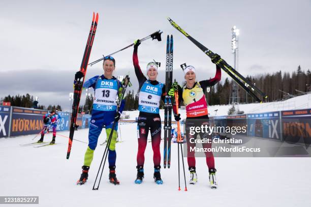 Third placed Hanna Sola of Belarus to the left, race winner Marte Olsbu Roeiseland of Norway in the center and runner up Tiril Eckhoff of Norway...