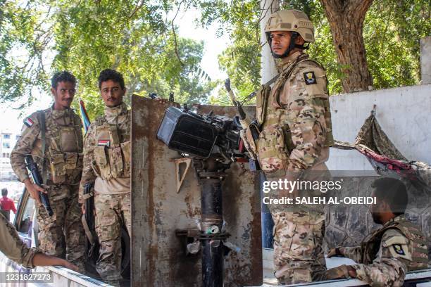 Fighters loyal to Yemen's separatist Southern Transitional Council bearing insignia showing the old flag of South Yemen are seen on guard near the...