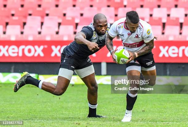 Elton Jantjies of the Lions challenged by Lukhanyo Am of the Sharks during the SA Rugby Preparation Series match between Emirates Lions and Cell C...