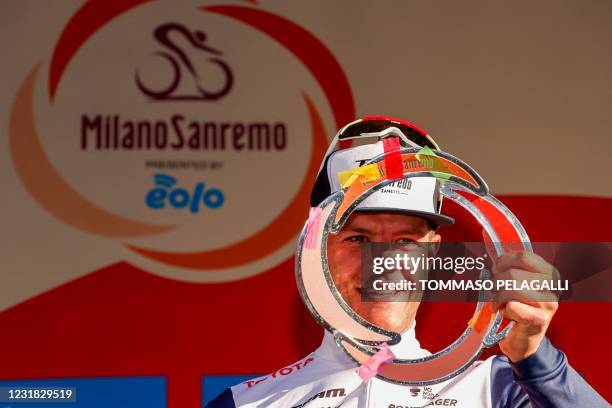 Team Trek rider Belgium's Jasper Stuyven celebrates on the podium after winning the one-day classic cycling race Milan-San Remo on March 20, 2021 in...