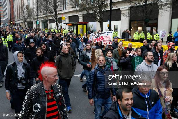 Protesters march during a "World Wide Rally For Freedom" protest on March 20, 2021 in London, England. "World Wide Rally For Freedom" protests, with...