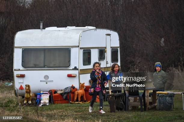 Gipsy kids playing in front of their caravan on Todorov Den also known as Horse Easter in Bulgaria. The Day of St. Theodore's is celebrated with...