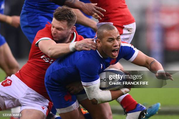 France's centre Gael Fickou is tackled by Wales' fly-half Dan Biggar during the Six Nations rugby union tournament match between France and Wales on...