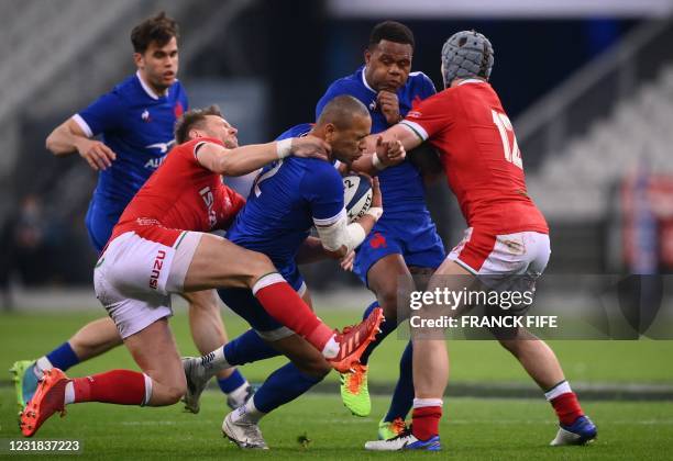 France's centre Gael Fickou is tackled by Wales' fly-half Dan Biggar during the Six Nations rugby union tournament match between France and Wales on...