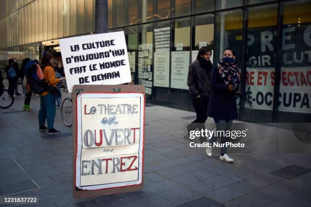 Placards read 'Today's culture makes the world of tomorrow' and 'The theater is open. Come in' in front of the National Theater of Toulouse, the...