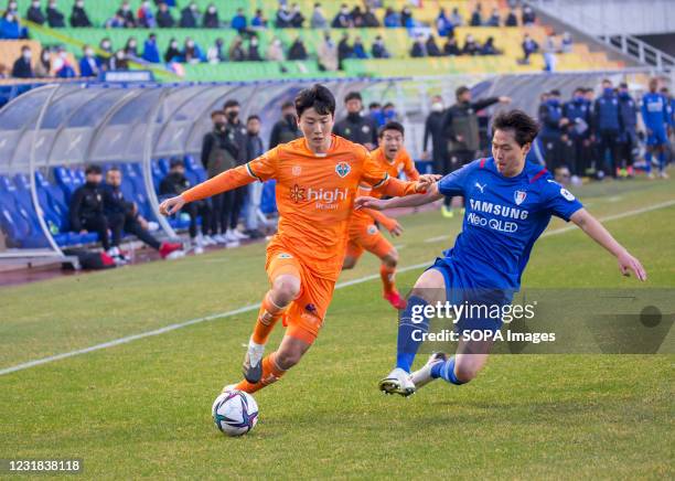 Kim Dong-Hyun of Gangwon FC and Kim Gun-Hee of Suwon Samsung Bluewings in action during the 4th round of the 2021 K League 1 soccer match between...