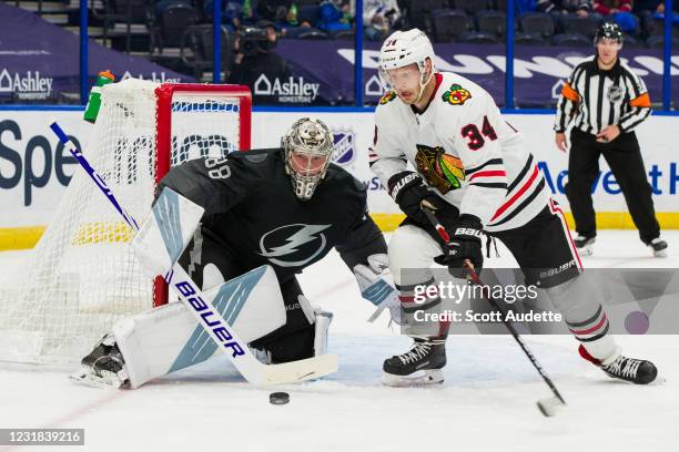 Goalie Andrei Vasilevskiy of the Tampa Bay Lightning looks for the rebound against Carl Soderberg of the Chicago Blackhawks during the second period...