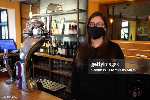 Landlady Emma Parkhouse poses for a photograph inside the Great Northern pub in St Albans, north of London on March 18, 2021. - Pots of paint rather...