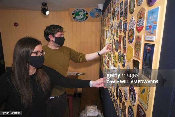 Landlady Emma Parkhouse and Landlord Sheridan Edwards pose for a photograph inside the Great Northern pub in St Albans, north of London on March 18,...