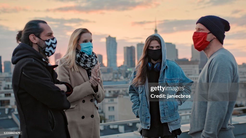 Hipster friends meeting on a rooftop. Social life during pandemic