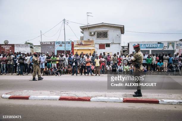Two soldiers from the first protection battalion of the incumbent Congo President, Denis Sassou Nguesso, stand guard as he arrives at the polling...