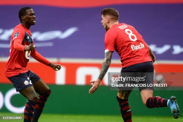 Lille's Portuguese midfielder Xeka celebrates with teammate after scoring a goal during the French L1 football match between Lille LOSC and Nimes...