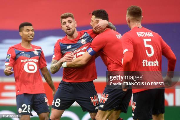 Lille's Portuguese midfielder Xeka is congratulated by teammates after scoring a goal during the French L1 football match between Lille LOSC and...