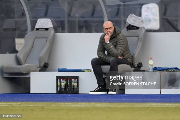 Leverkusen's Dutch head coach Peter Bosz looks on from the bench during the German first division Bundesliga football match between Hertha Berlin and...