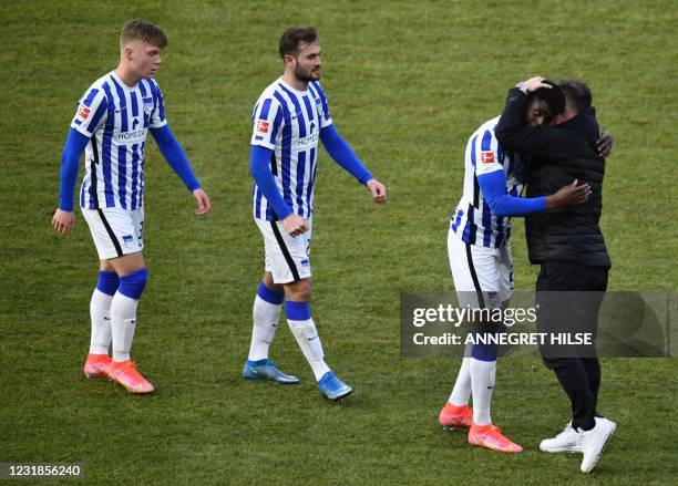 Hertha Berlin's Hungarian head coach Pal Dardai congratulates Hertha Berlin's German defender Jordan Torunarigha, Hertha Berlin's French midfielder...