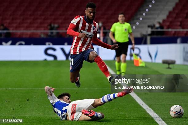 Atletico Madrid's French midfielder Thomas Lemar challenges Alaves' Spanish defender Ximo Navarro during the Spanish League football match between...