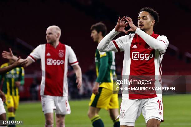 Ajax' Dutch defender Devyne Rensch celebrates following the 1-0 during the Dutch Eredivisie match between Ajax Amsterdam and ADO Den Haag at the...