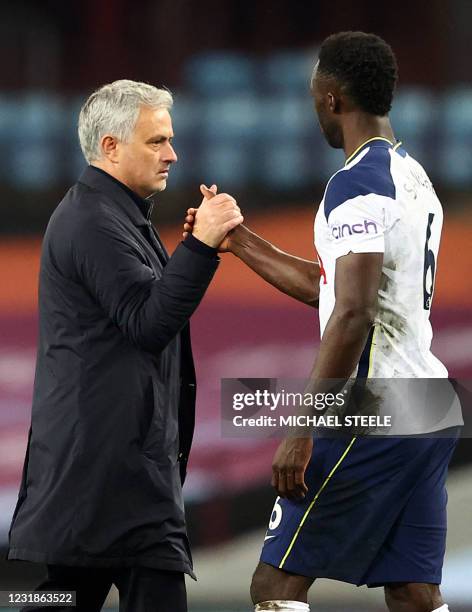 Tottenham Hotspur's Portuguese head coach Jose Mourinho shakes hands with Tottenham Hotspur's Colombian defender Davinson Sanchez after the English...