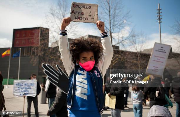 Child holds a placard reading "Afro-Basque" during the demonstration. Demonstrators take to the streets of Pamplona on the occasion of the...