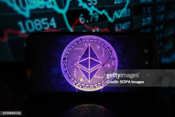 In this photo illustration an Ethereum logo seen displayed on a smartphone with stock market percentages in the background.