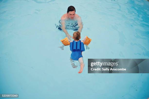 child being taught how to swim - arm band stock pictures, royalty-free photos & images