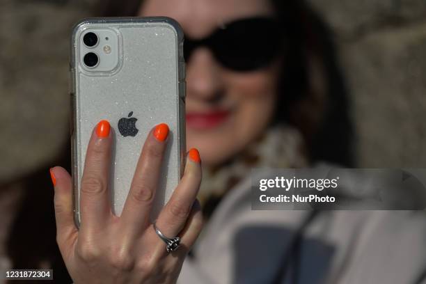 Woman holds an iPhone in Dún Laoghaire, Dublin, during Level 5 Covid-19 lockdown. On Sunday, 21 March in Dublin, Ireland.