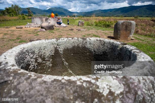 Tourists take pictures while visiting the Pokokea Megalith Site in Hanggira Village, Lore Tengah District, Poso Regency, Central Sulawesi, Indonesia...