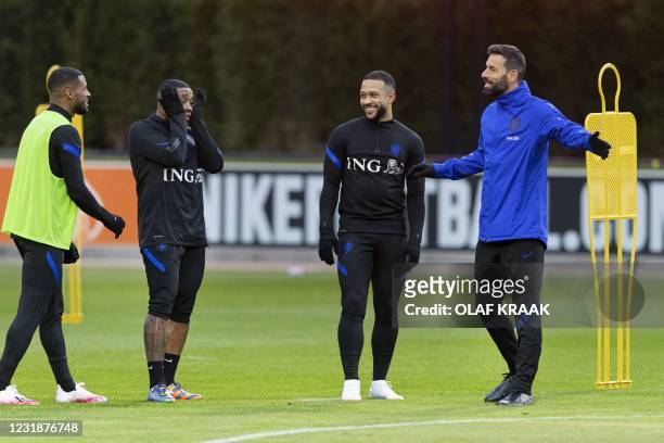 Netherlands' assistant coach Ruud van Nistelrooij shares a laugh with Memphis Depay, Steven Bergwijn, and Georginio Wijnaldum of the Dutch national...