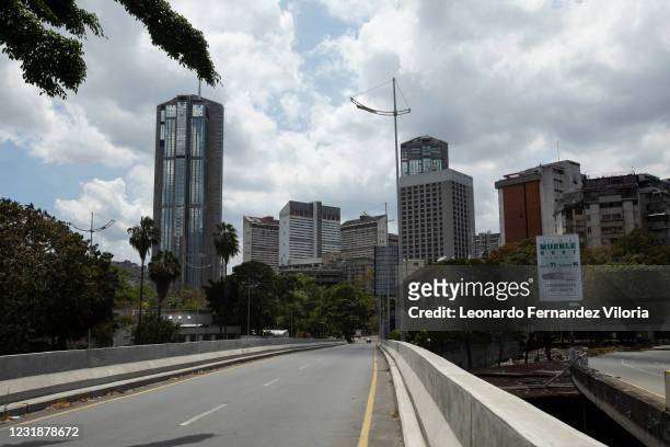 One of the main streets to enter the city center is almost empty during the first day of the strict curfew ordered by President Maduro on March 22,...