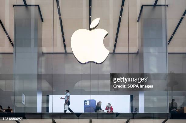 Customers are seen at the American multinational technology company Apple store in Hong Kong.