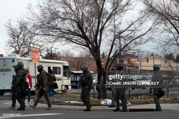Swat team personnel walk outside the King Soopers grocery store in Boulder, Colorado on March 22, 2021 after reports of an active shooter. - A gunman...
