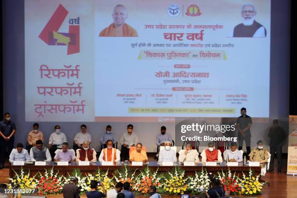 Yogi Adityanath, chief minister of Uttar Pradesh, center left, speaks during a news conference in Lucknow, India, on Friday, March 19, 2021. The...