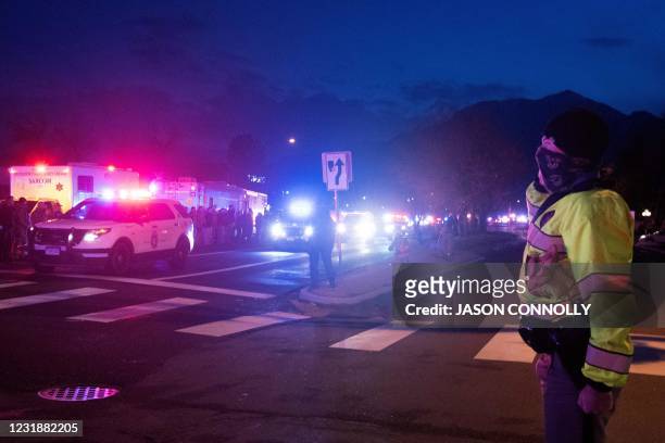 Colorado State Patrol trooper salutes as a motorcade carrying fallen Boulder Police officer Eric Talley exits the King Soopers grocery store in...